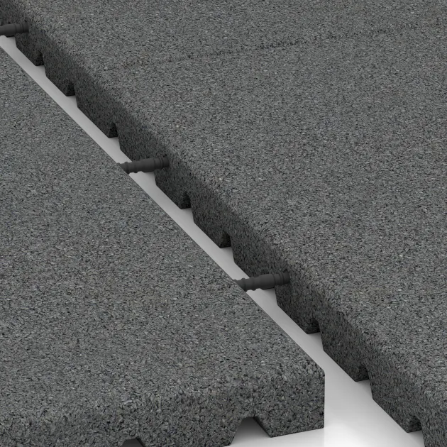 Le gros plan sur le système de connexion des revêtements de sol WARCO 5663 - Tapis aire de jeux 4 cm - EN 1177 ≤ 110 cm en couleur Gris ardoise. Les dimensions 1000 x 1000 x 40 mm.