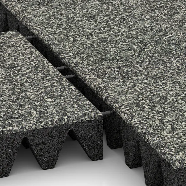 Le gros plan sur le système de connexion des revêtements de sol WARCO 5644 - Dalle amortissante 10 cm - EN 1177 ≤ 300 cm en couleur Granit classique. Les dimensions 500 x 500 x 100 mm.